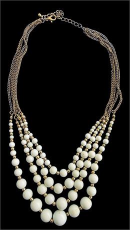 Cascading white and gold tone bead bib statement necklace