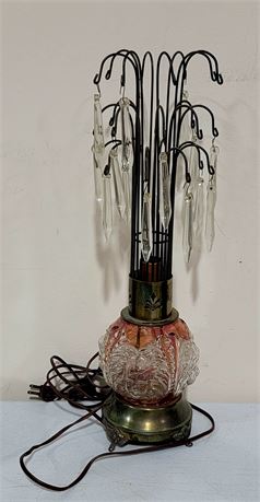 Vintage lamp adorned with crystals and features a gorgeous glass base